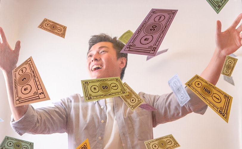 Man with expression of wonder standing in cubicle, surrounded by notes flying around his head.